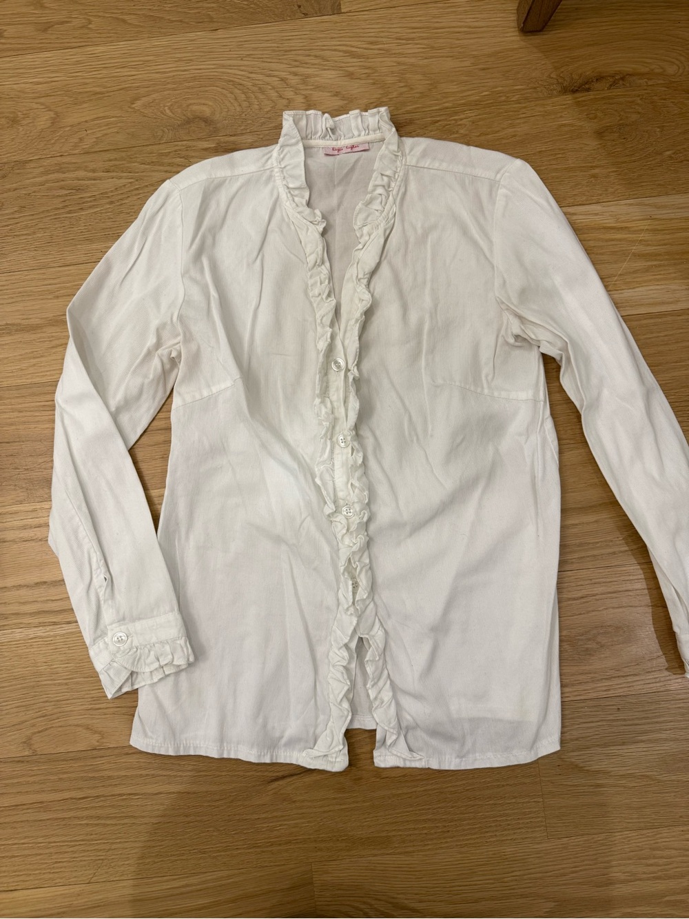 Kayce Hughes white long sleeve ruffle blouse